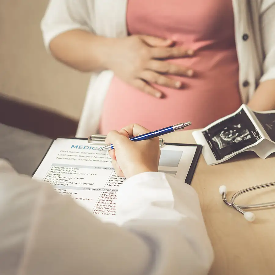 Diagnostic Ultrasound Services - young pregnant woman is sitting, speaking with her doctor about baby's development and health - Salem, IL